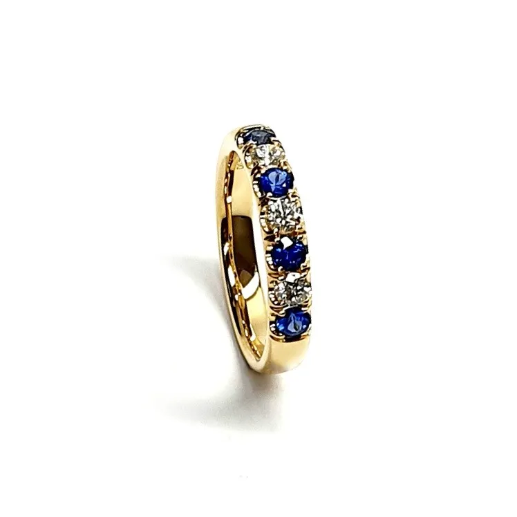 18ct Yellow Gold Blue Sapphire & Diamond Eternity Ring RA00686 Four 2.8mm round sapphires and three 2.8mm round diamonds ring standing up to the front angled facing to the right. Close up with a white background close up