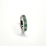 18ct White Gold Emerald & Diamond Eternity Ring RA00685 Four 2.8mm round emeralds and three 2.8mm round diamonds ring standing up to the front angled facing to the right. With a white background.
