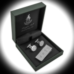 Hallmarked sterling silver money clip and cufflinks in Douglas Pearl gift box, illuminated by a circular spotlight against a darkened background