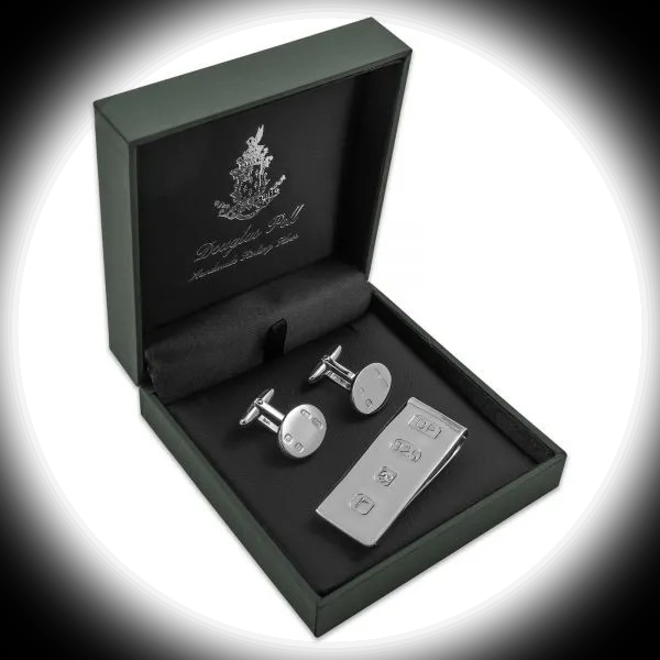 Hallmarked sterling silver money clip and cufflinks in Douglas Pearl gift box, illuminated by a circular spotlight against a darkened background