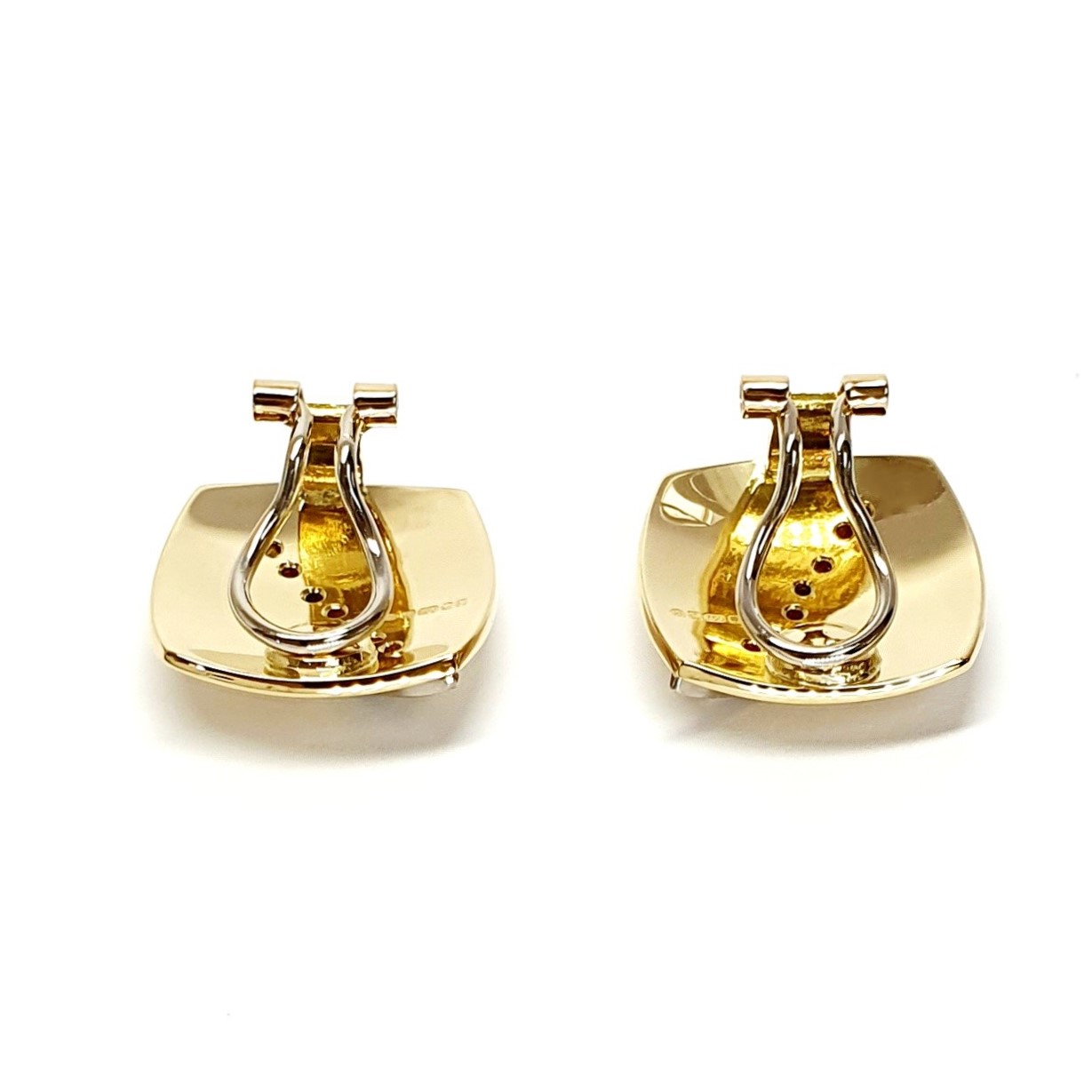 Measurements 16mm x 16mm. And 19mm corner to corner Handmade 18ct yellow gold curved cushion-shaped clip-on earrings with an 18ct white gold wave going from corner to corner set with seven graduated round white diamonds to each earring.