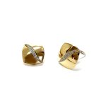 Measurements 16mm x 16mm. And 19mm corner to corner Handmade 18ct yellow gold curved cushion-shaped clip-on earrings with an 18ct white gold wave going from corner to corner set with seven graduated round white diamonds to each earring.