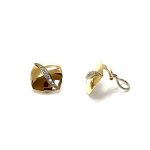 Measurements 16mm x 16mm. And 19mm corner to corner Handmade 18ct yellow gold curved cushion-shaped clip-on earrings with an 18ct white gold wave going from corner to corner set with seven graduated round white diamonds to each earring.