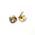 Measurements 16mm x 16mm. And 19mm corner to corner Handmade 18ct yellow gold curved cushion-shaped clip-on earrings with an 18ct white gold wave going from corner to corner set with seven graduated round white diamonds to each earring.