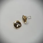 Measurements 16mm x 16mm. And 19mm corner to corner Handmade 18ct yellow gold curved cushion-shaped clip-on earrings with an 18ct white gold wave going from corner to corner set with seven graduated round white diamonds to each earring.