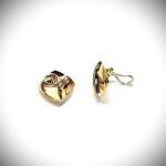 Measurements 16mm x 16mm. And 19mm corner to corner Handmade 18ct yellow gold curved cushion-shaped clip-on earrings with an 18ct white gold wave going from corner to corner set with seven graduated round white diamonds to each earring.