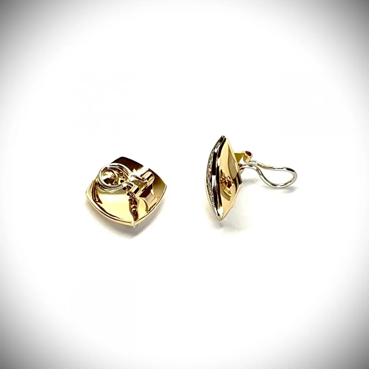 Measurements 16mm x 16mm. And 19mm corner to corner Handmade 18ct yellow gold curved cushion-shaped clip-on earrings with an 18ct white gold wave going from corner to corner set with seven graduated round white diamonds to each earring.
