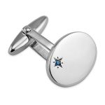 Handmade oval sterling silver cufflinks have a single offset rich blue sapphire in an enhancing starburst setting.
