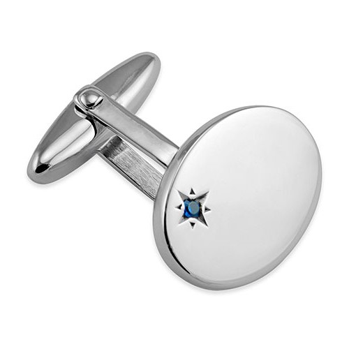 Handmade oval sterling silver cufflinks have a single offset rich blue sapphire in an enhancing starburst setting.