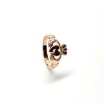 A 9ct rose gold Claddagh ring (Irish fáinne Chladaigh) is a traditional Irish ring in which a heart represents love, the crown stands for loyalty, and two clasped hands symbolize friendship.