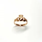A 9ct rose gold Claddagh ring (Irish fáinne Chladaigh) is a traditional Irish ring in which a heart represents love, the crown stands for loyalty, and two clasped hands symbolize friendship.