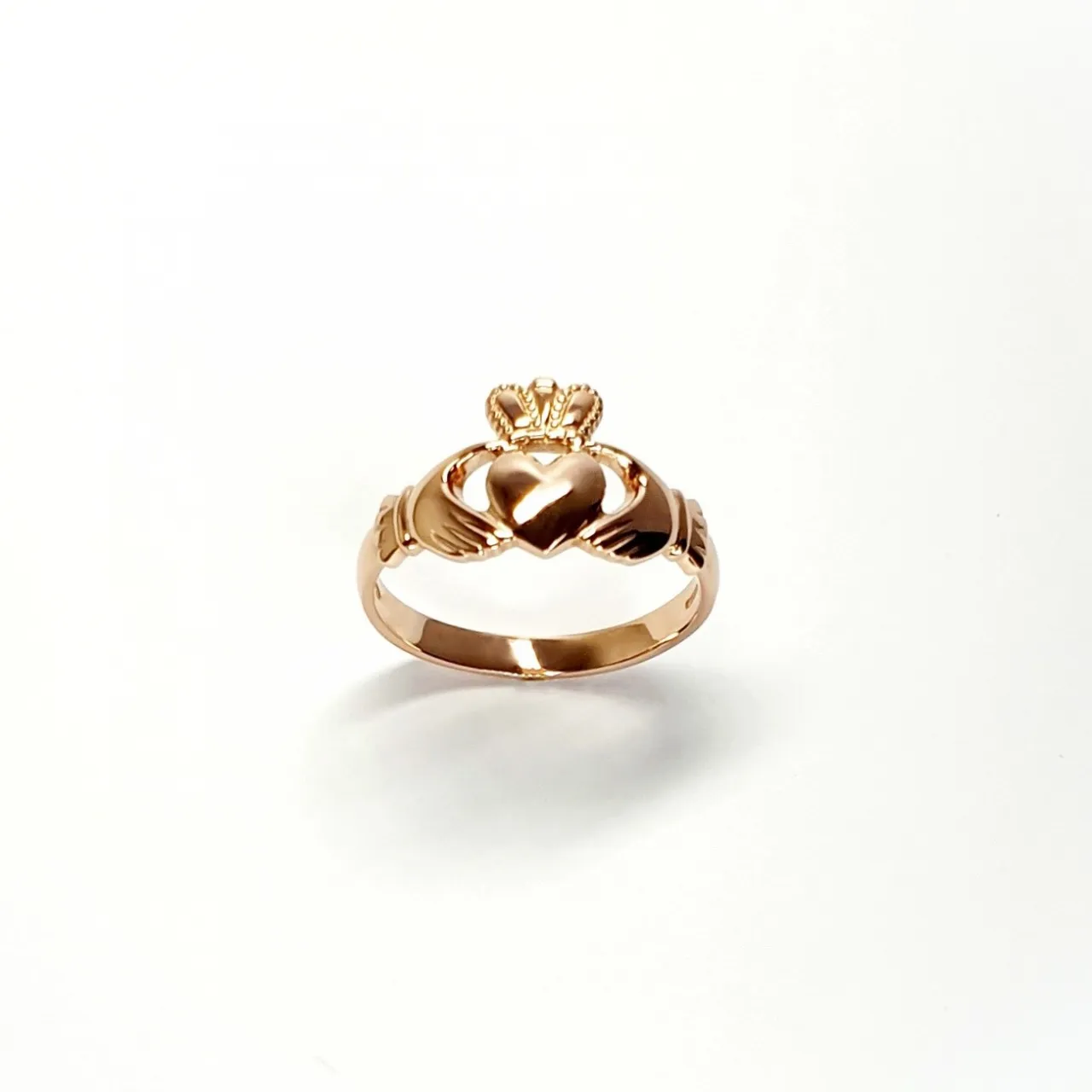 A 9ct rose gold Claddagh ring (Irish fáinne Chladaigh) is a traditional Irish ring in which a heart represents love, the crown stands for loyalty, and two clasped hands symbolize friendship.
