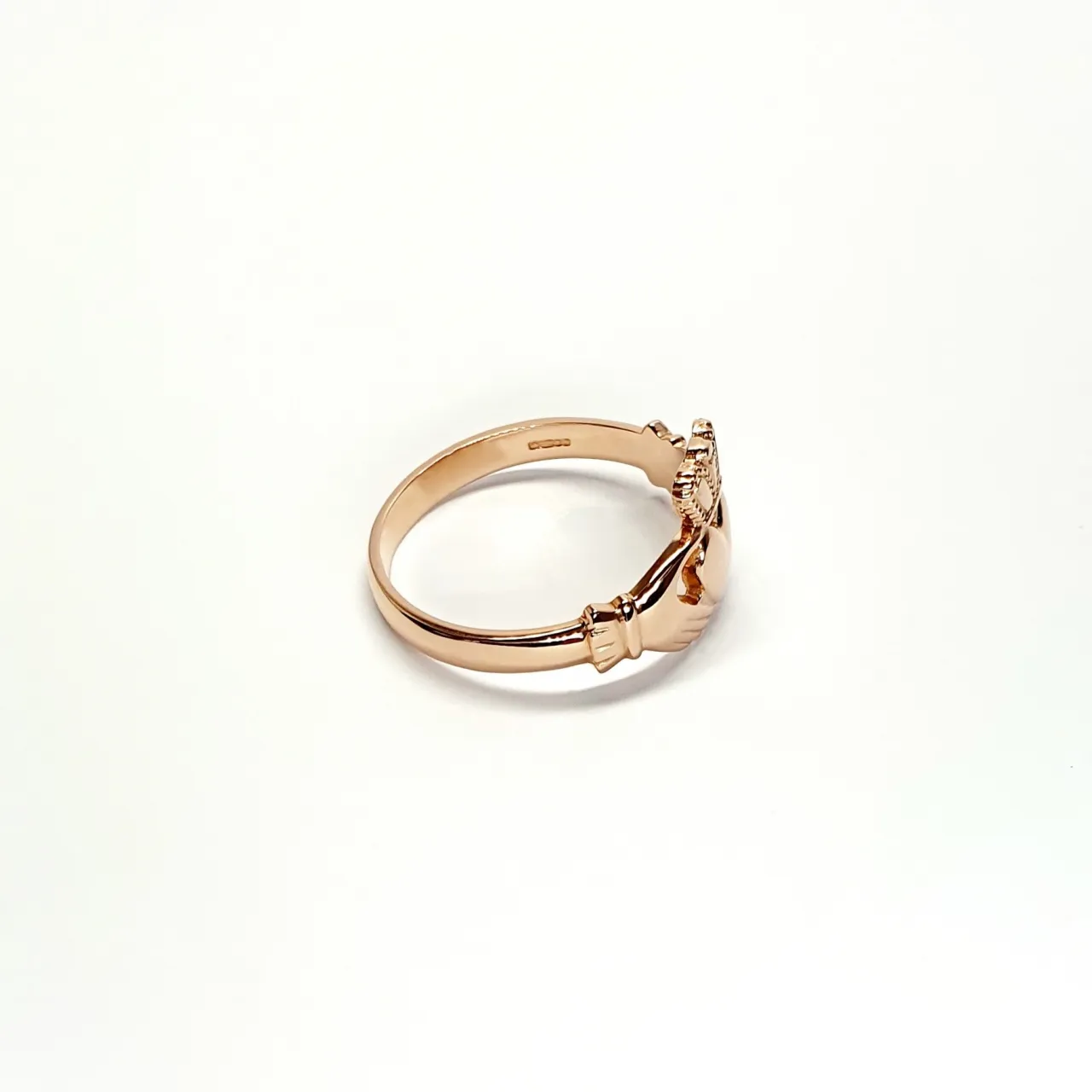 A 9ct rose gold Claddagh ring (Irish fáinne Chladaigh) is a traditional Irish ring in which a heart represents love, the crown stands for loyalty, and two clasped hands symbolize friendship.