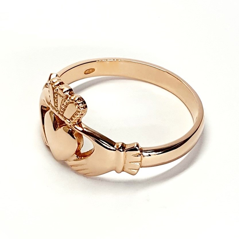 A 9ct rose gold Claddagh ring (Irish fáinne Chladaigh) is a traditional Irish ring in which a heart represents love, the crown stands for loyalty, and two clasped hands symbolize friendship.