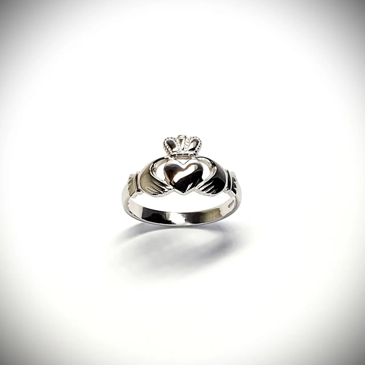 A 9ct white gold Claddagh ring (Irish fáinne Chladaigh) is a traditional Irish ring in which a heart represents love, the crown stands for loyalty, and two clasped hands symbolize friendship.