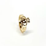 A 9ct yellow gold Claddagh ring (Irish fáinne Chladaigh) is a traditional Irish ring in which a heart represents love, the crown stands for loyalty, and two clasped hands symbolize friendship.