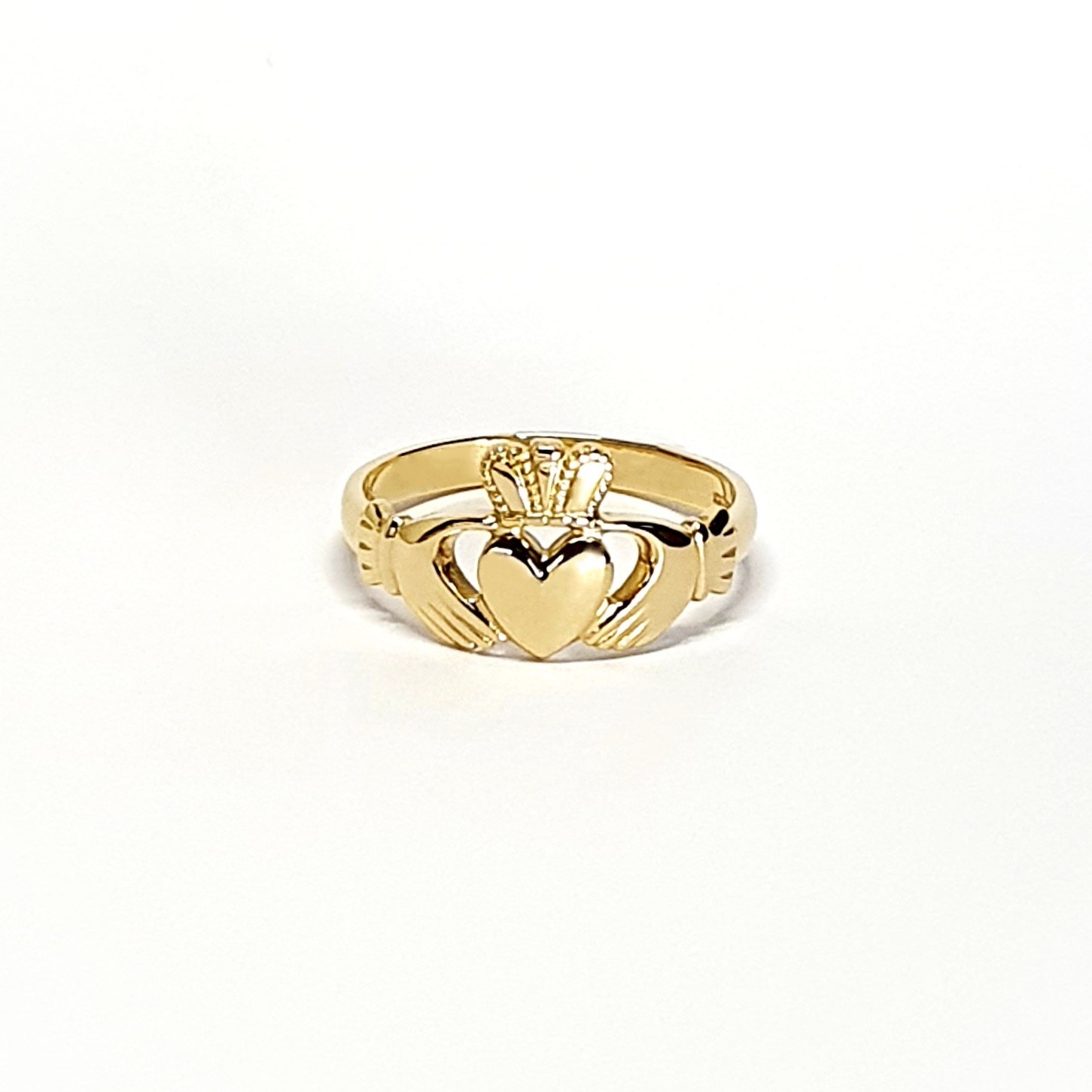 A 9ct yellow gold Claddagh ring (Irish fáinne Chladaigh) is a traditional Irish ring in which a heart represents love, the crown stands for loyalty, and two clasped hands symbolize friendship.