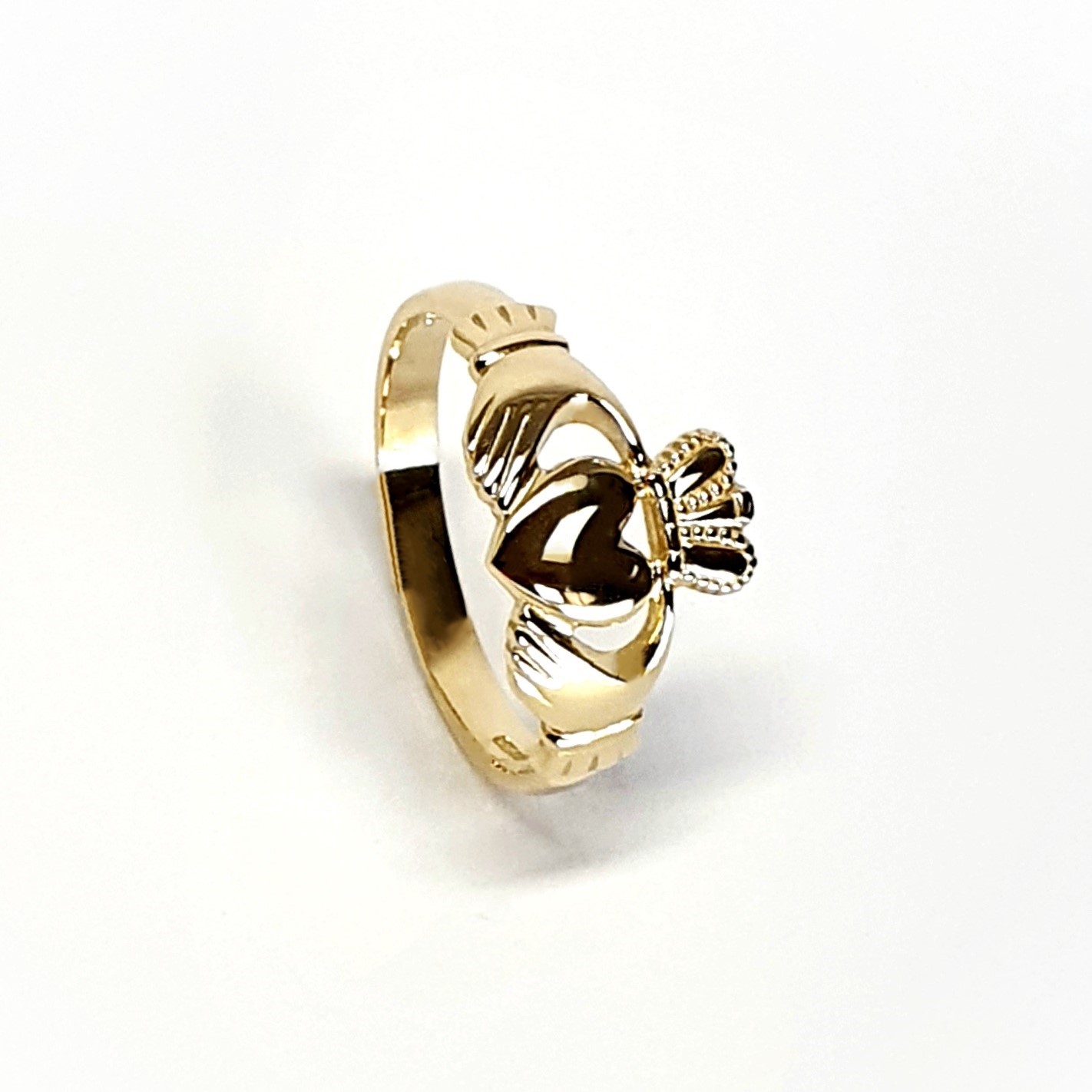 A 9ct yellow gold Claddagh ring (Irish fáinne Chladaigh) is a traditional Irish ring in which a heart represents love, the crown stands for loyalty, and two clasped hands symbolize friendship.