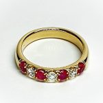 18ct yellow gold ruby and diamond half eternity ring set with three round white diamonds and four round blood red rubies, a solid tactile ring with rounded edges