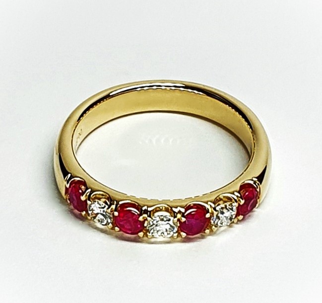 18ct yellow gold ruby and diamond half eternity ring set with three round white diamonds and four round blood red rubies, a solid tactile ring with rounded edges