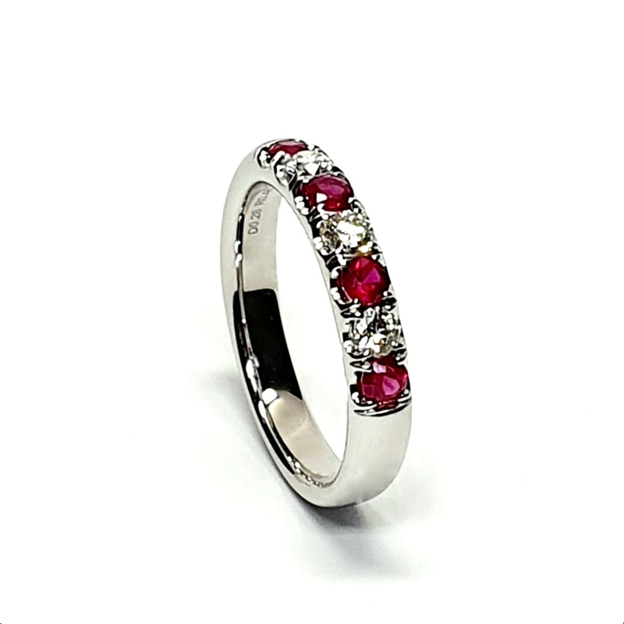 18ct white gold ruby and diamond half eternity ring set with three round white diamonds and four round blood red rubies, a solid tactile ring with rounded edges.