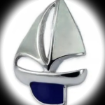 Silver sailing boat cufflinks with a polished silver hull, blue keel and white enamel sails evoke the essence of sailing. dimensions 25mm x 16mm pictured in a spot light showing front only