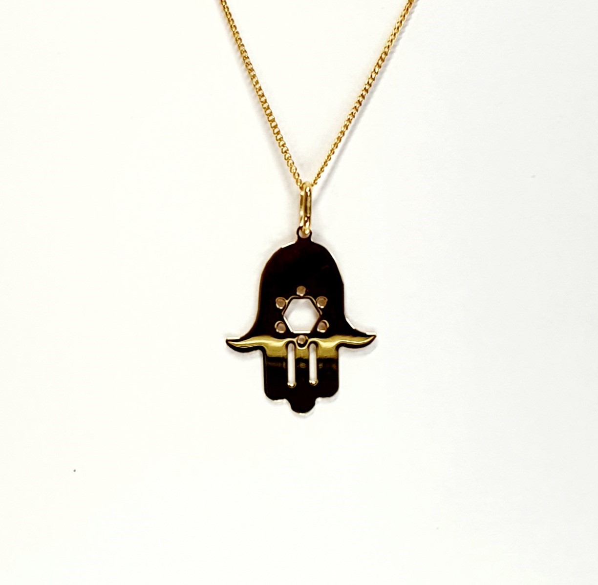 This Hamsa Pendant/necklace incorporates a cut-out design of a Star of David of filigree style with a diamond cut pattern for extra sparkle. Back view.