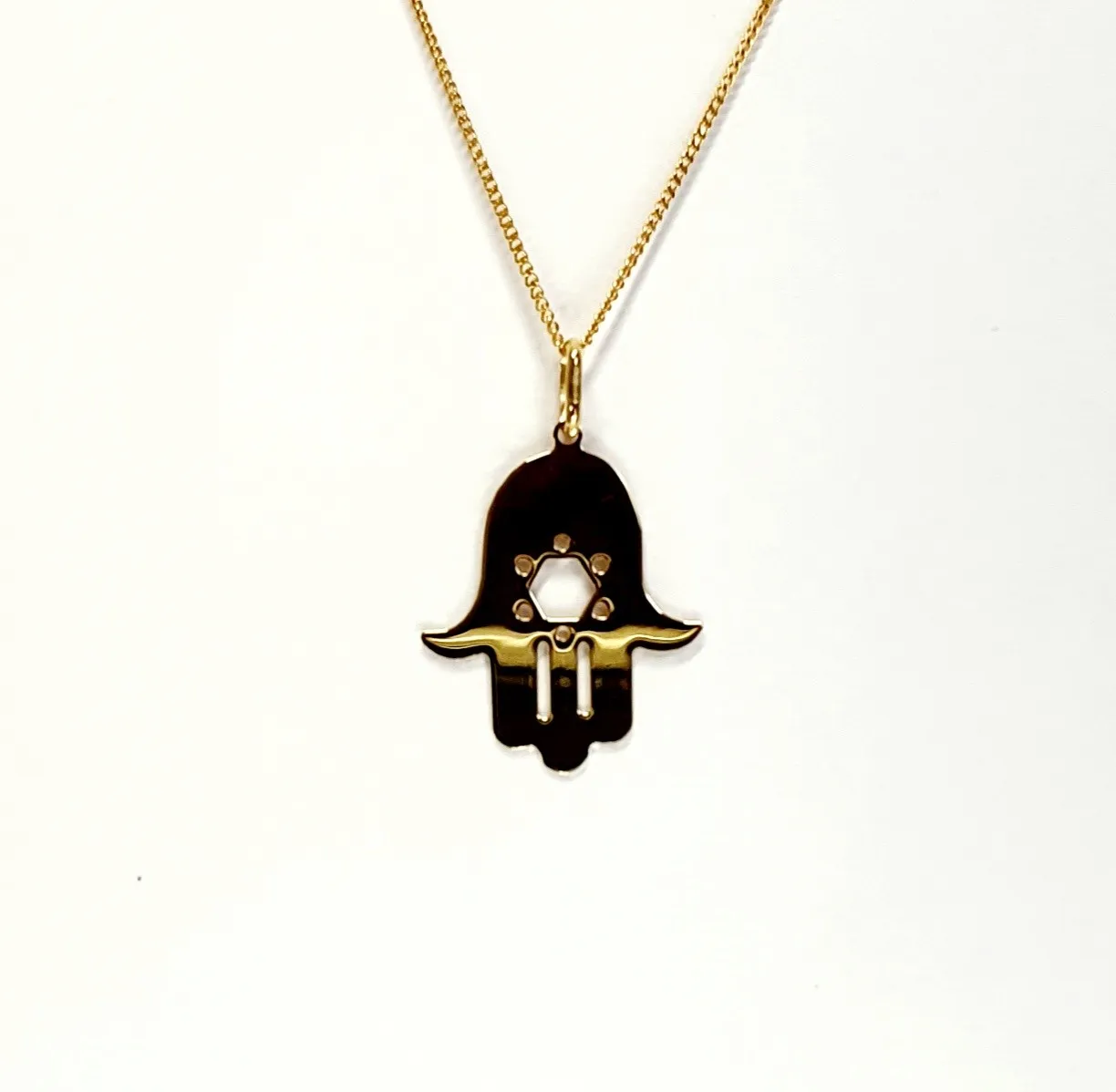 This Hamsa Pendant/necklace incorporates a cut-out design of a Star of David of filigree style with a diamond cut pattern for extra sparkle. Back view.