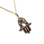 This Hamsa Pendant/necklace incorporates a cut-out design of a Star of David of filigree style with a diamond cut pattern for extra sparkle.