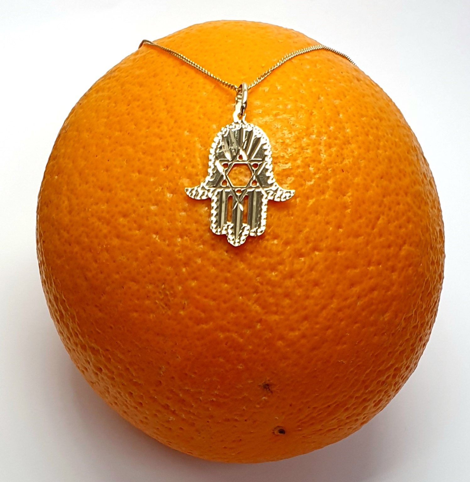 This Hamsa Pendant/necklace incorporates a cut-out design of a Star of David of filigree style with a diamond cut pattern for extra sparkle.