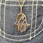 This Hamsa Pendant/necklace incorporates a cut-out design of a Star of David of filigree style with a diamond cut pattern for extra sparkle.