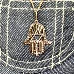 This Hamsa Pendant/necklace incorporates a cut-out design of a Star of David of filigree style with a diamond cut pattern for extra sparkle.