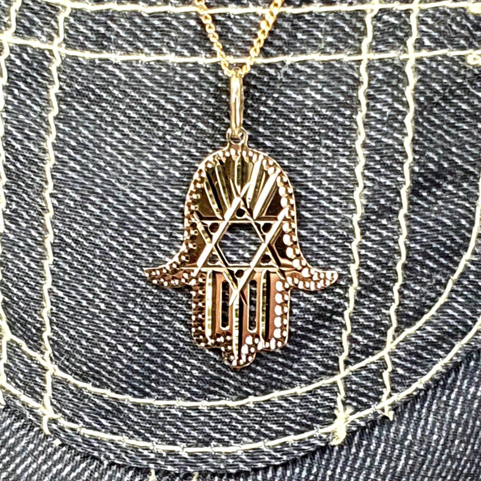 This Hamsa Pendant/necklace incorporates a cut-out design of a Star of David of filigree style with a diamond cut pattern for extra sparkle.
