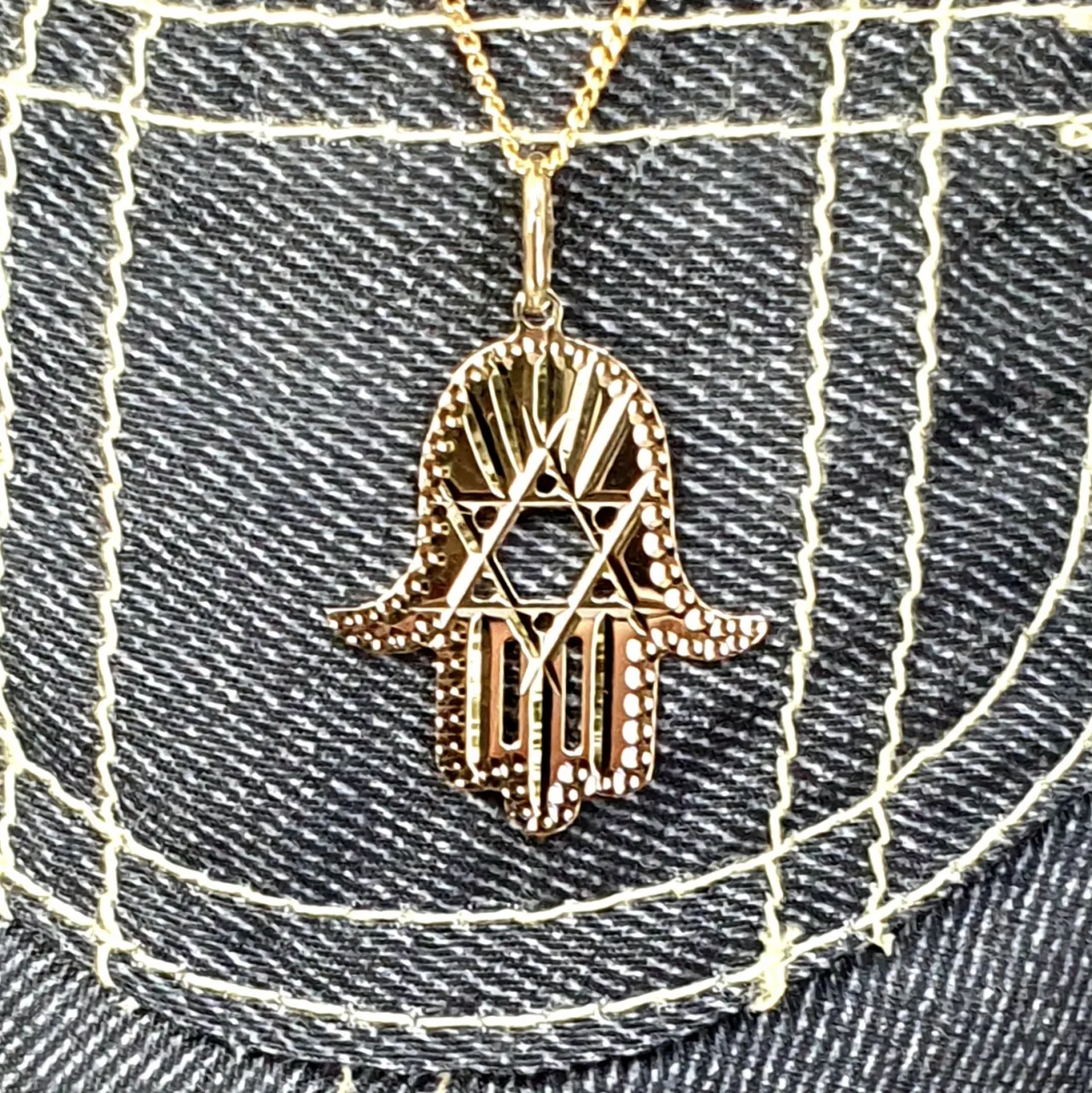 This Hamsa Pendant/necklace incorporates a cut-out design of a Star of David of filigree style with a diamond cut pattern for extra sparkle.