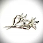 Sterling silver lily flower brooch with two stems.