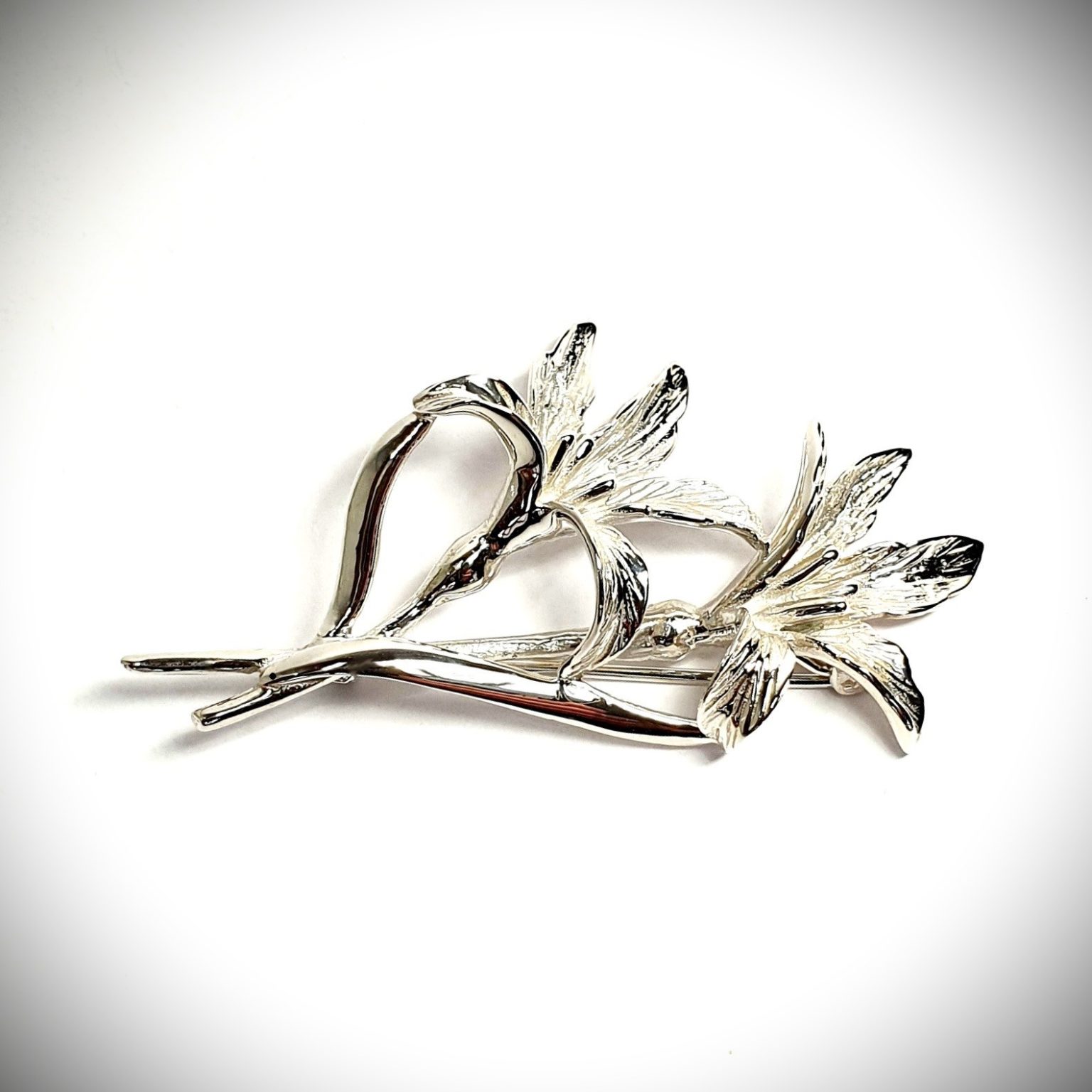 Sterling silver lily flower brooch with two stems.