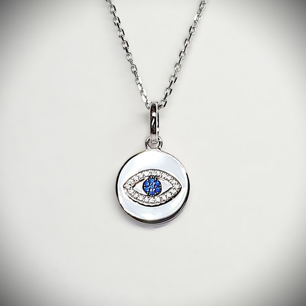 A round disc silver evil eye necklace/pendant made in real sterling silver with sparkling blue & white cubic zirconia with a highly polished finish.