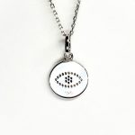 A round disc silver evil eye necklace/pendant made in real sterling silver with sparkling blue & white cubic zirconia with a highly polished finish. Back view.