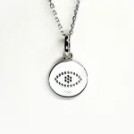 A round disc silver evil eye necklace/pendant made in real sterling silver with sparkling blue & white cubic zirconia with a highly polished finish. Back view.