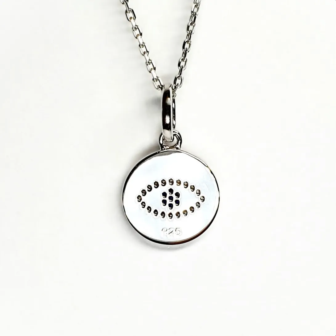 A round disc silver evil eye necklace/pendant made in real sterling silver with sparkling blue & white cubic zirconia with a highly polished finish. Back view.