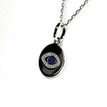 A round disc silver evil eye necklace/pendant made in real sterling silver with sparkling blue & white cubic zirconia with a highly polished finish.