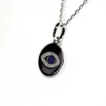 A round disc silver evil eye necklace/pendant made in real sterling silver with sparkling blue & white cubic zirconia with a highly polished finish.