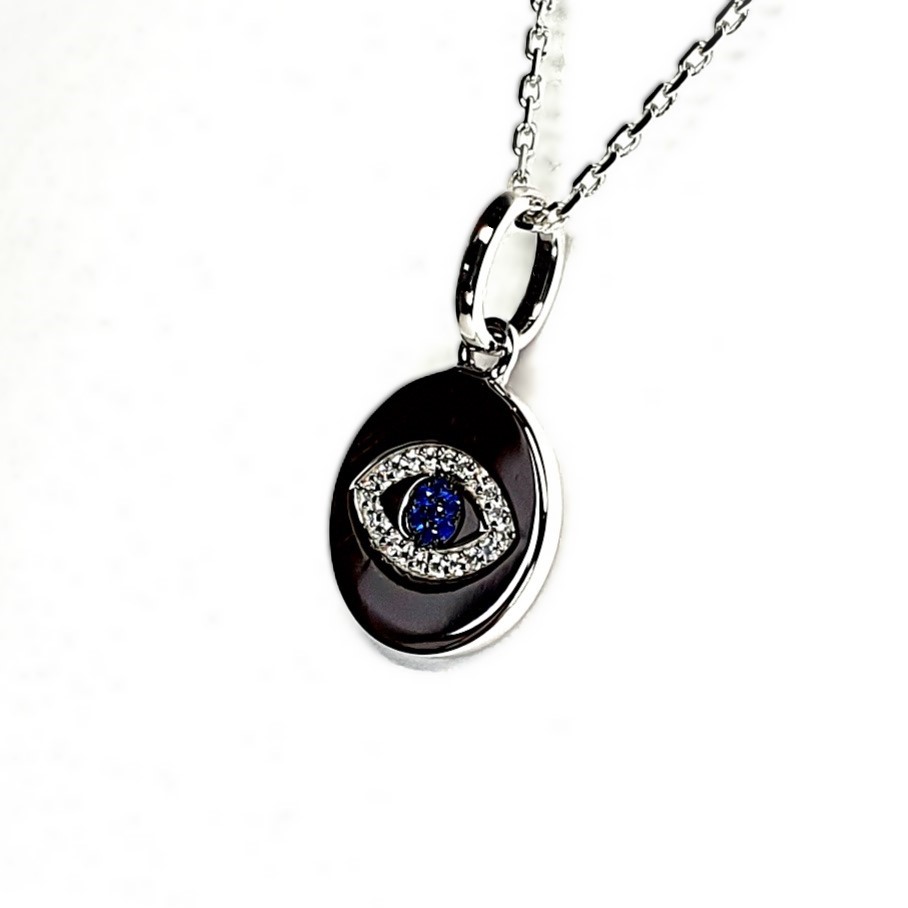 A round disc silver evil eye necklace/pendant made in real sterling silver with sparkling blue & white cubic zirconia with a highly polished finish.