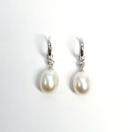 18ct white gold polished huggie loop/hoop earrings leading to a single round diamond and then onto  a single oval pearl drop.