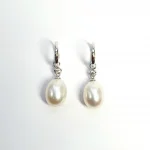 18ct white gold polished huggie loop/hoop earrings leading to a single round diamond and then onto  a single oval pearl drop.