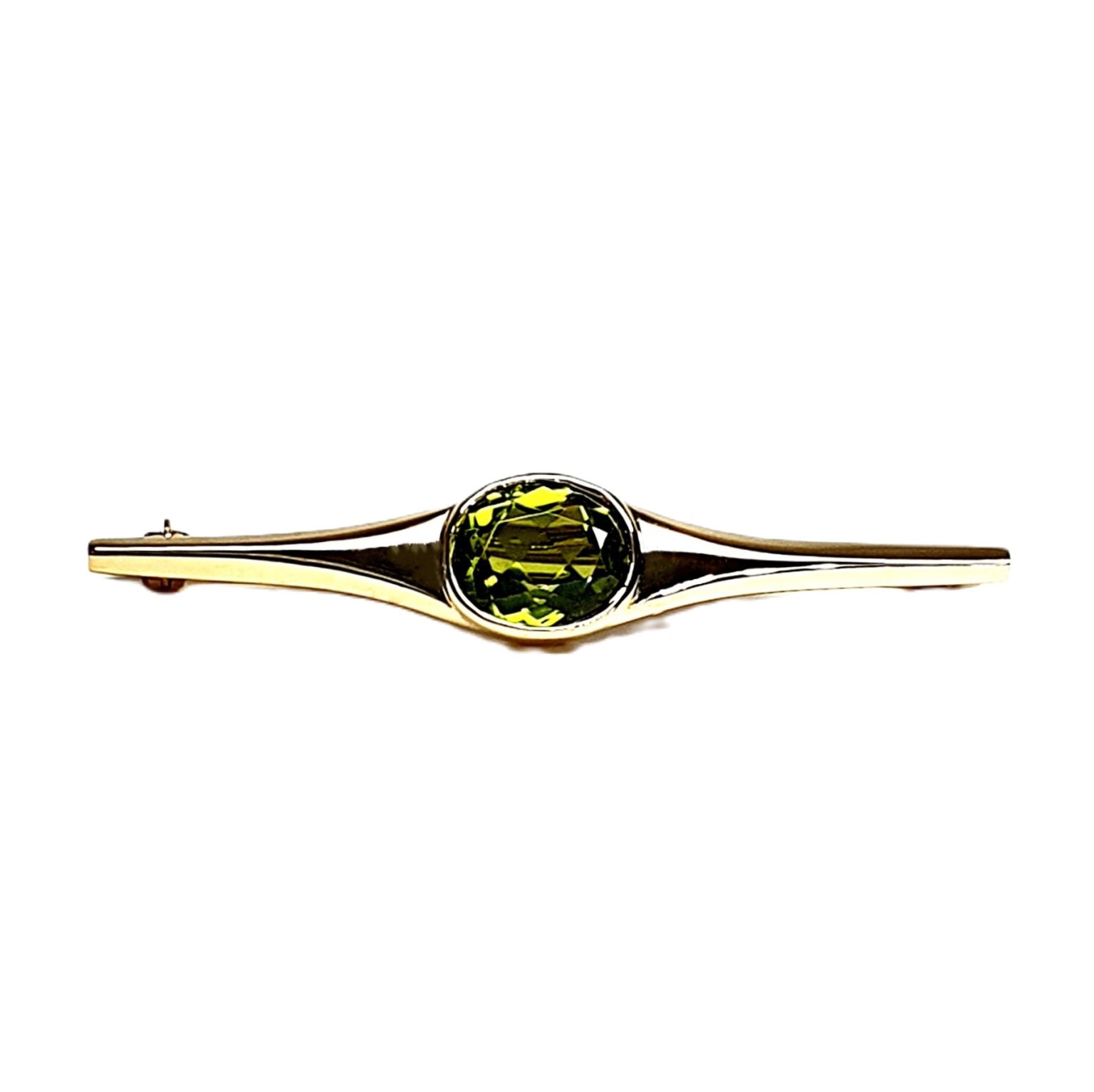 9ct yellow gold pre-loved bar brooch with an oval peridot gemstone in a landscape rub-over setting with a straight pin and a swivel safety catch.