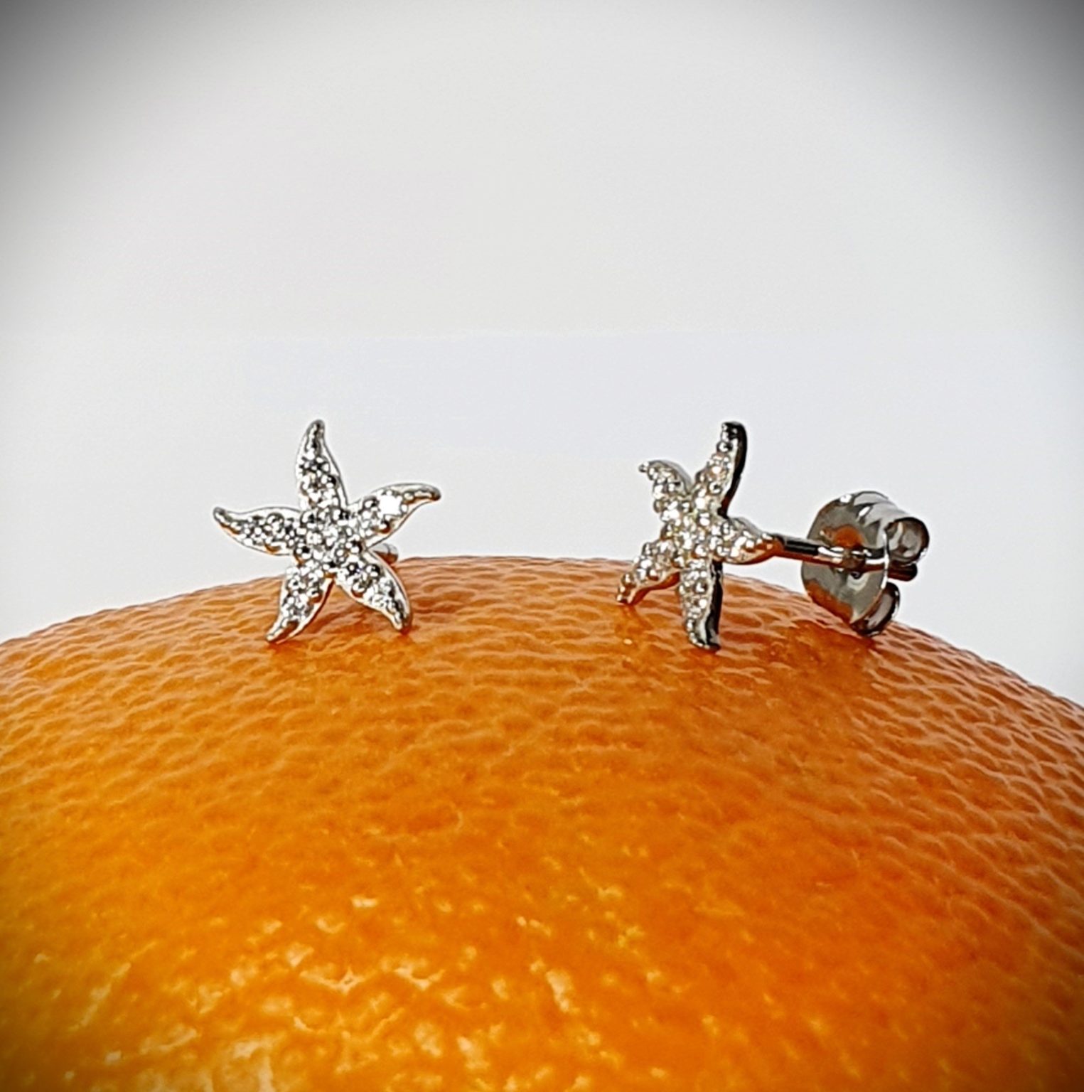9ct white gold starfish stud earrings set with eleven cubic zirconia's to each stud ES00789.