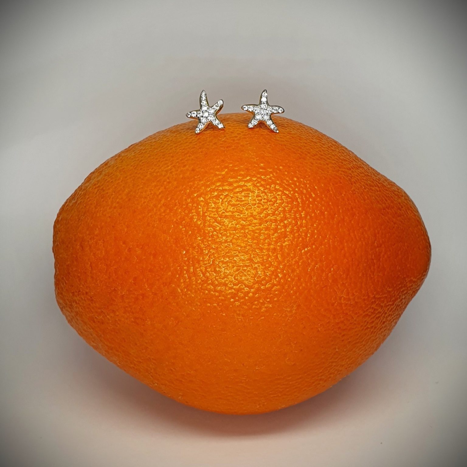 9ct yellow gold starfish stud earrings set with seventeen cubic zirconia's to each stud ES00790 10mm.