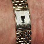 9ct yellow gold watch bracelet GWQ00018  handmade in the United Kingdom, each solid link has been carefully put together and soldered by hand with thick gold pins, and the sturdy gold clasp has a gorgeous engine-turned pattern with a plain cartouche suitable for engraving if you so wish.