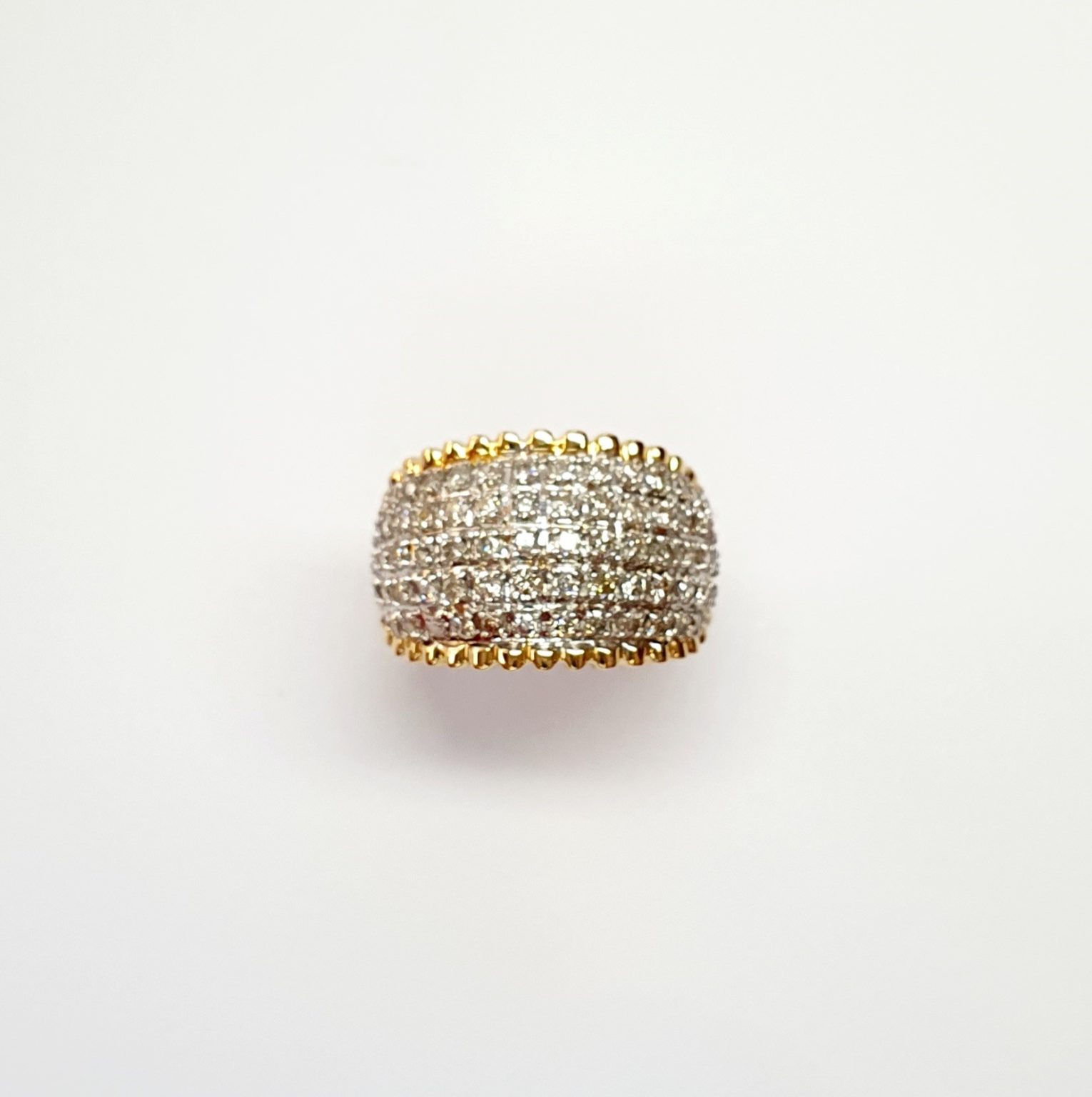 Bombay ring with Seventy round diamonds In a rhodium Pave setting, the total diamond weight is approx. one carat with 7.8 grams of 18ct yellow gold width at the top widest part is 13.6mm tapering to 3.6mm at the back